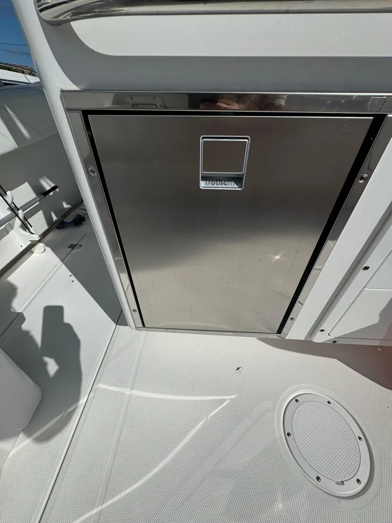 Slide: The Image of 2019 Edgewater 280CC boat interior with stainless steel storage compartment. - 24