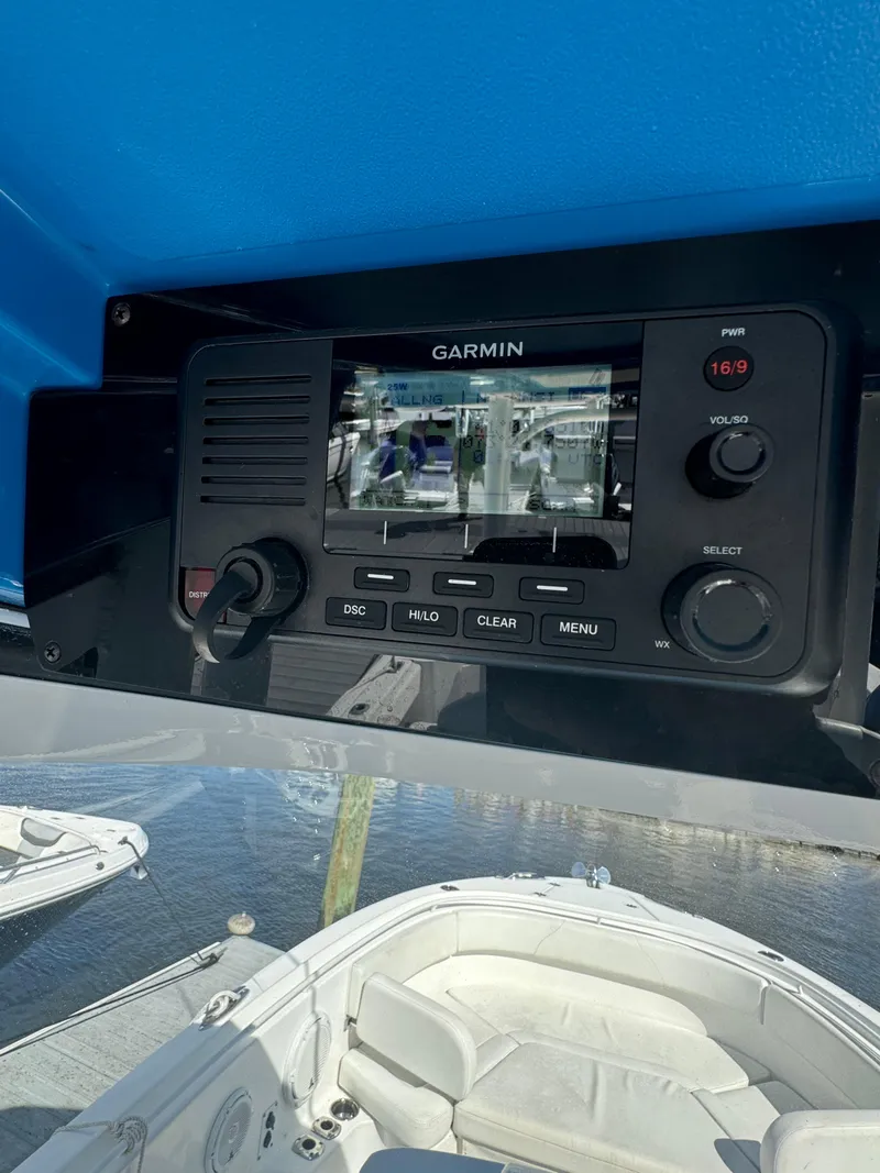 Slide: The Image of Garmin navigation system on 2019 Edgewater 280CC boat, docked by the water. - 30