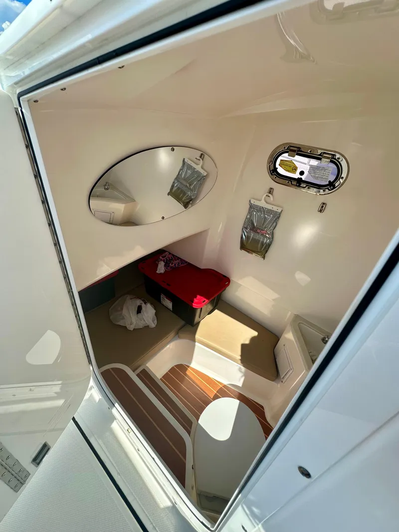 Slide: The Image of Interior cabin of 2019 Edgewater 280CC boat with seating and storage. - 5