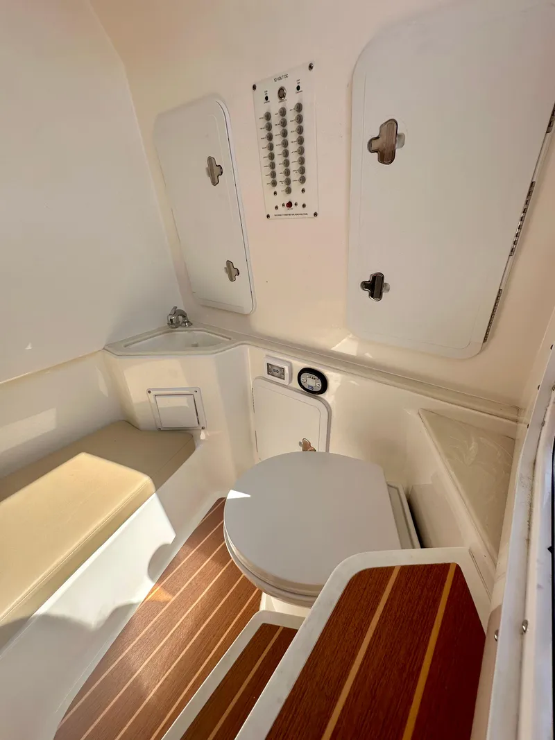 Slide: The Image of 2019 Edgewater 280CC boat interior with toilet and storage compartments. - 6
