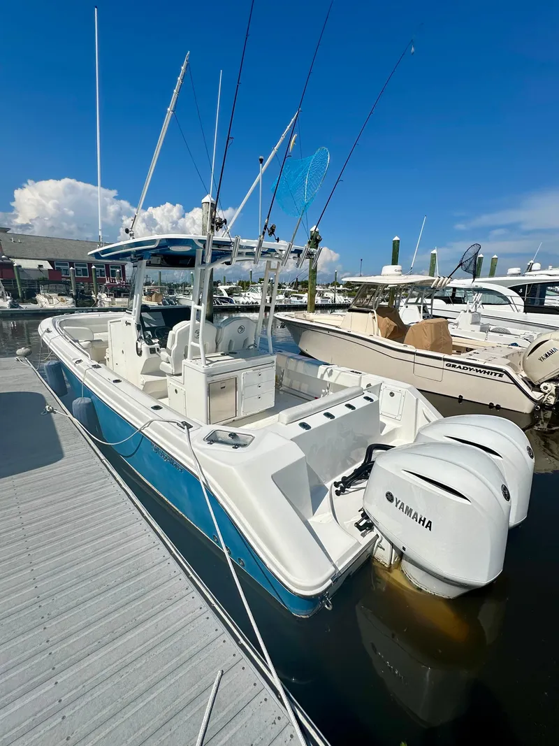 Slide: The Image of 2019 Edgewater 280CC boat docked with twin Yamaha engines. - 8