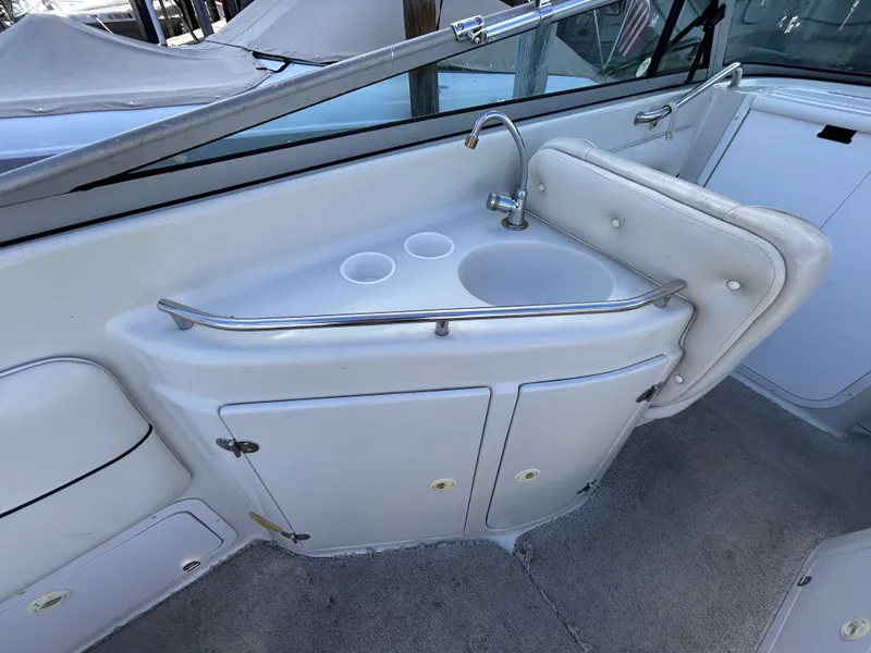 Slide: The Image of 2000 Crownline 266 CCR boat interior with sink and storage cabinets. - 12