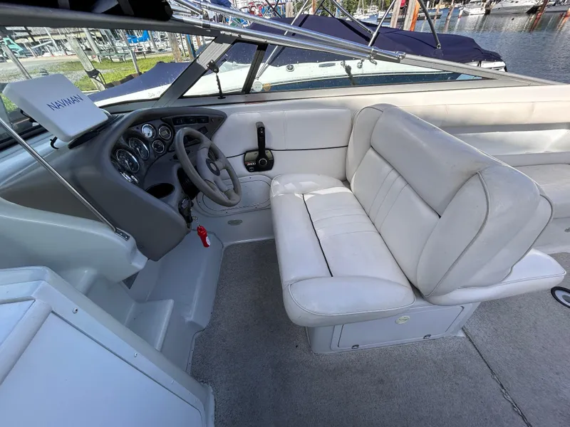 Slide: The Image of 2000 Crownline 266 CCR boat interior with white seating and steering wheel. - 13