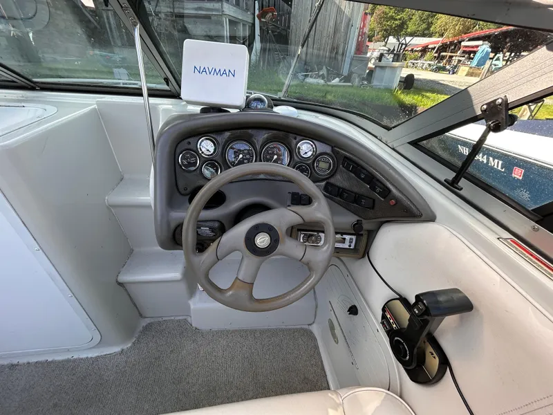 Slide: The Image of Crownline 266 CCR 2000 boat dashboard with steering wheel and navigation instruments. - 15