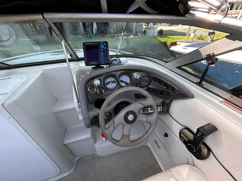 Slide: The Image of 2000 Crownline 266 CCR boat cockpit with steering wheel and instrument panel. - 16