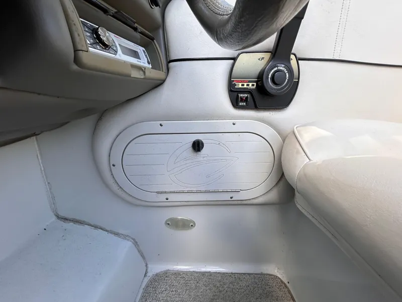 Slide: The Image of Interior of 2000 Crownline 266 CCR boat, featuring steering wheel and control panel. - 17