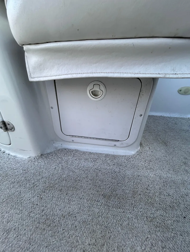 Slide: The Image of Crownline 266 CCR 2000 boat interior storage compartment with carpeted flooring. - 21