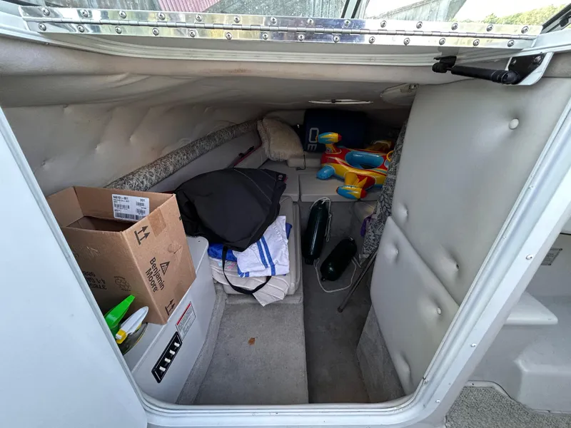 Slide: The Image of Interior cabin of 2000 Crownline 266 CCR boat with storage items. - 23