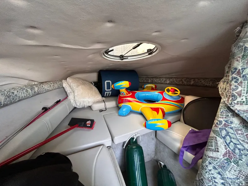 Slide: The Image of Interior cabin of 2000 Crownline 266 CCR with toys and boating equipment. - 24