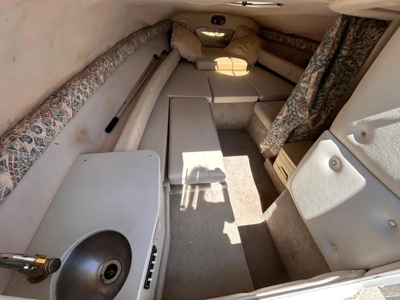 Slide: The Image of Interior of 2000 Crownline 266 CCR boat with seating and kitchenette. - 26