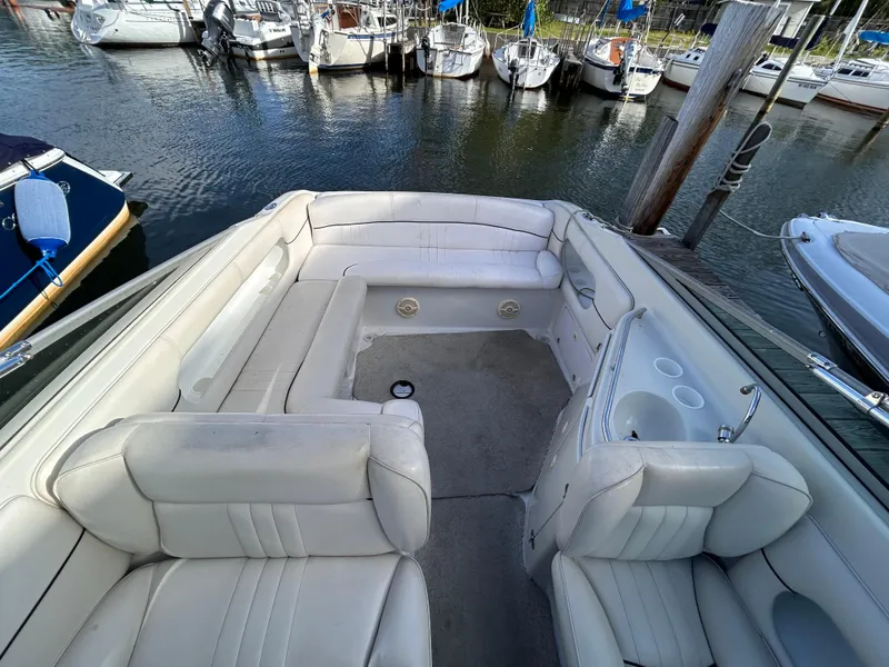 Slide: The Image of Crownline 266 CCR 2000 boat interior with white seating, docked at marina. - 4
