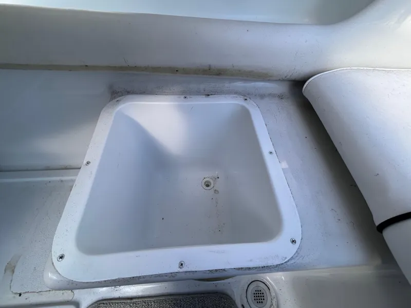 Slide: The Image of Crownline 266 CCR 2000 boat interior storage compartment, white and spacious. - 8