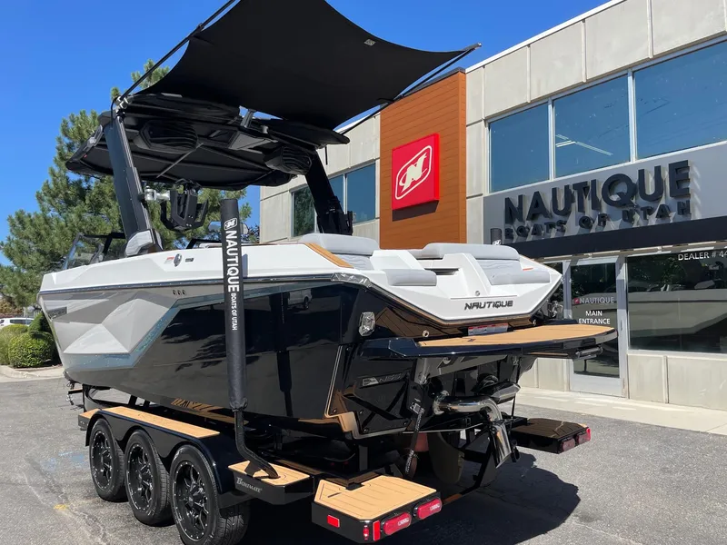 Slide: The Image of 2025 Nautique G23 boat on trailer outside dealership. - 3