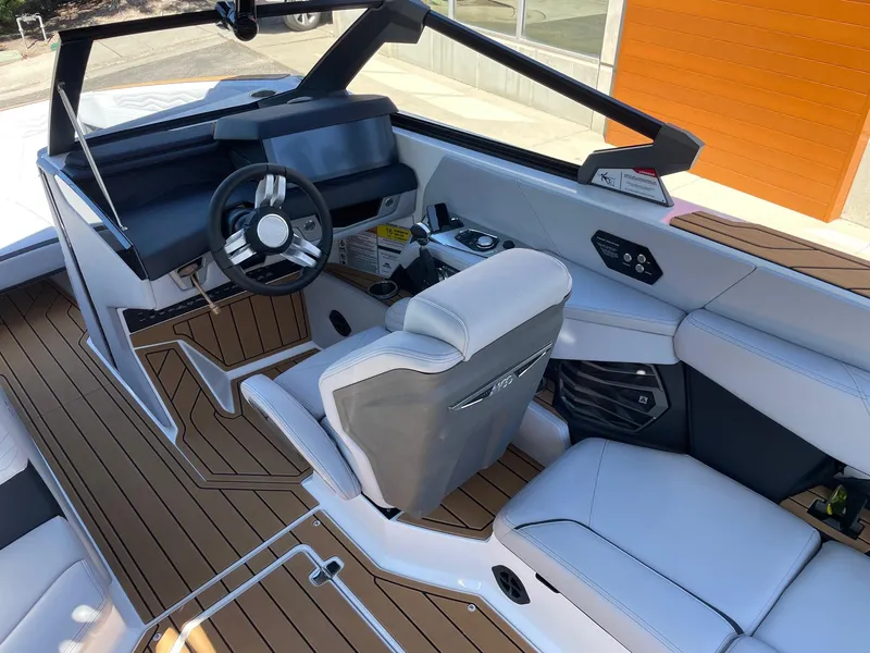 Slide: The Image of 2025 Nautique G23 boat interior with modern dashboard and seating. - 6