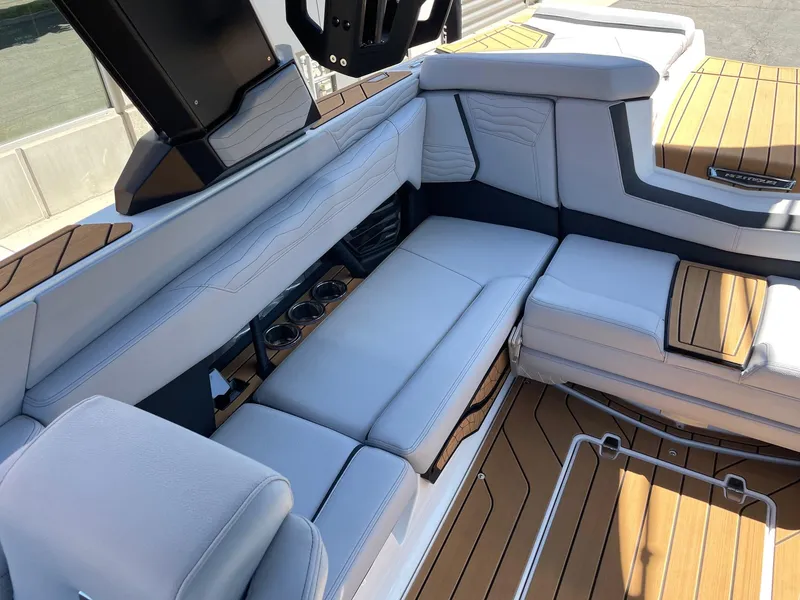 Slide: The Image of 2025 Nautique G23 boat interior with luxurious seating and teak flooring. - 7