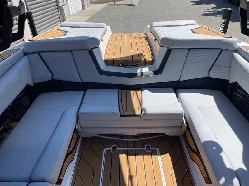 Slide: The Image of 2025 Nautique G23 boat interior with luxurious seating and teak flooring. - 8