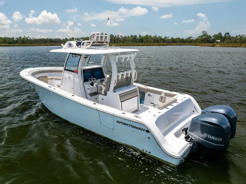 Slide: The Image of 2021 Sportsman Open 302 Center Console boat on calm water, featuring twin Yamaha engines. - 10