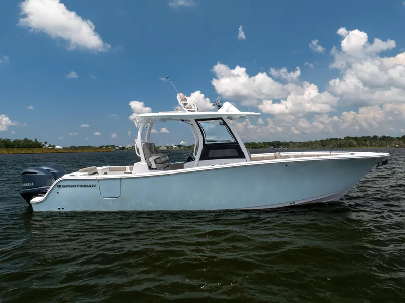Slide: The Image of 2021 Sportsman Open 302 Center Console boat on calm water under blue sky. - 19
