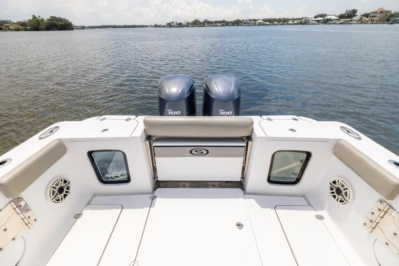 Slide: The Image of 2021 Sportsman Open 302 Center Console boat with twin engines on calm water. - 22