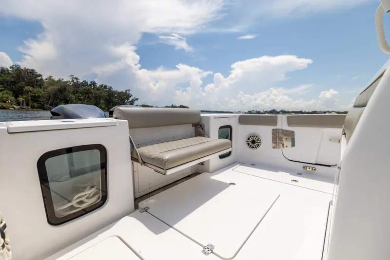 Slide: The Image of 2021 Sportsman Open 302 Center Console boat interior with seating and storage. - 27