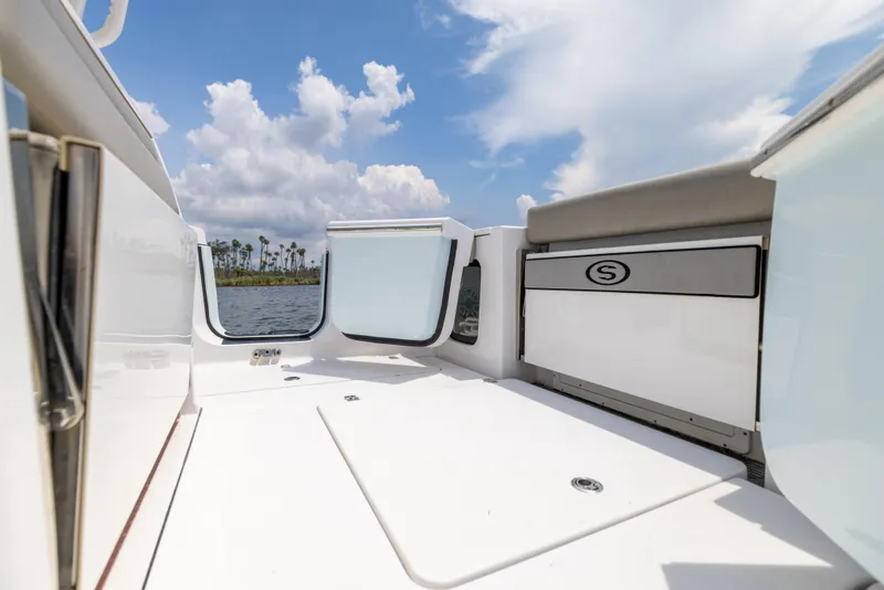 Slide: The Image of 2021 Sportsman Open 302 Center Console boat interior with open deck and storage. - 28