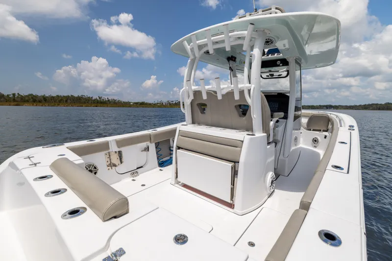 Slide: The Image of 2021 Sportsman Open 302 Center Console boat on calm water under blue sky. - 29
