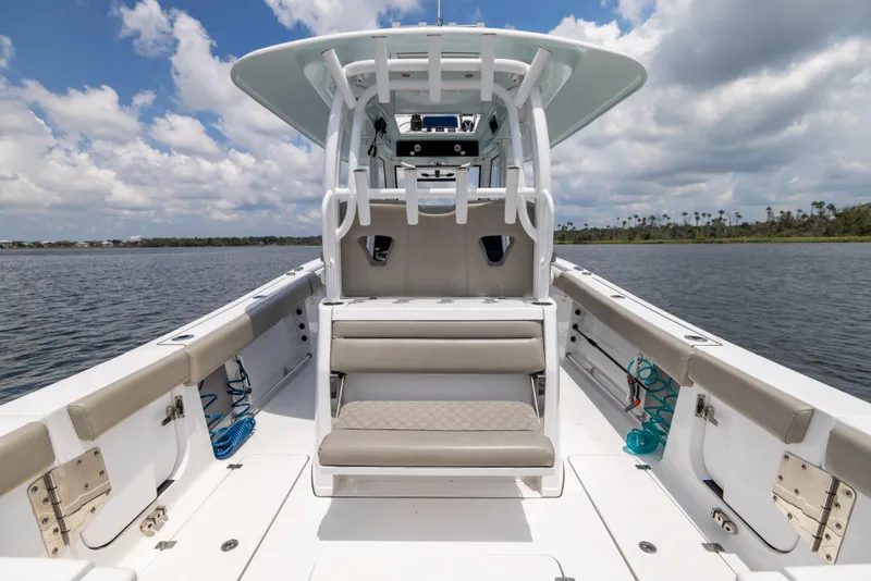 Slide: The Image of 2021 Sportsman Open 302 Center Console boat on calm water under cloudy sky. - 31
