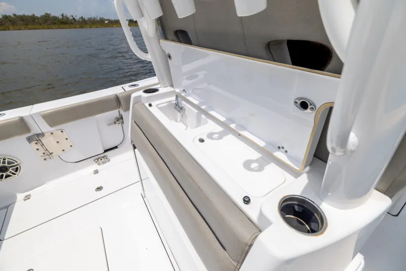 Slide: The Image of 2021 Sportsman Open 302 Center Console boat interior with seating and storage. - 32