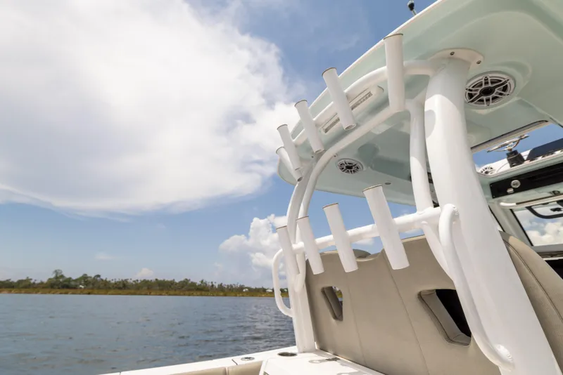 Slide: The Image of 2021 Sportsman Open 302 Center Console boat on a sunny day, featuring rod holders. - 33