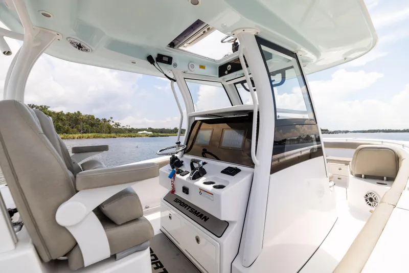Slide: The Image of 2021 Sportsman Open 302 Center Console boat interior with helm and seating. - 34