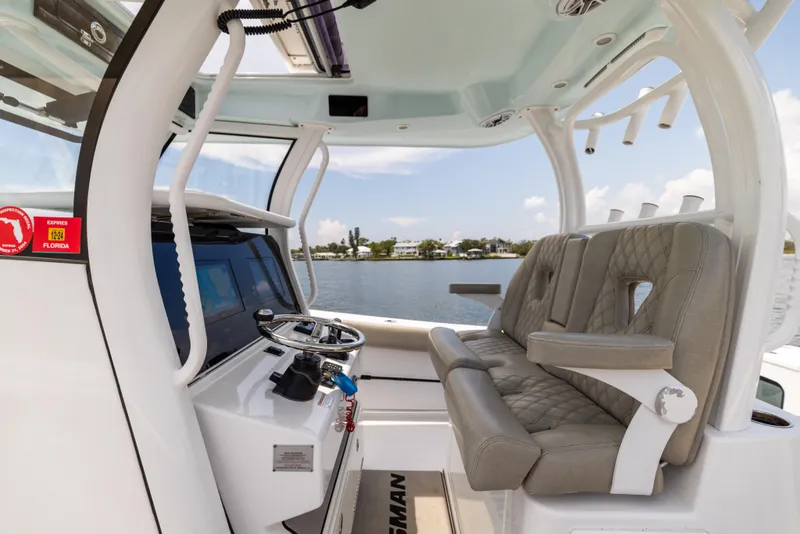 Slide: The Image of 2021 Sportsman Open 302 Center Console boat interior with helm and seating. - 37
