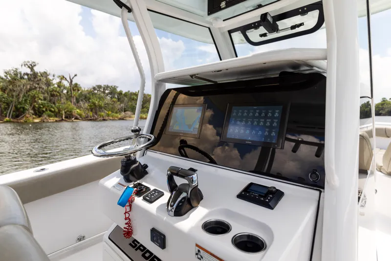 Slide: The Image of 2021 Sportsman Open 302 Center Console boat interior with modern dashboard and steering. - 38