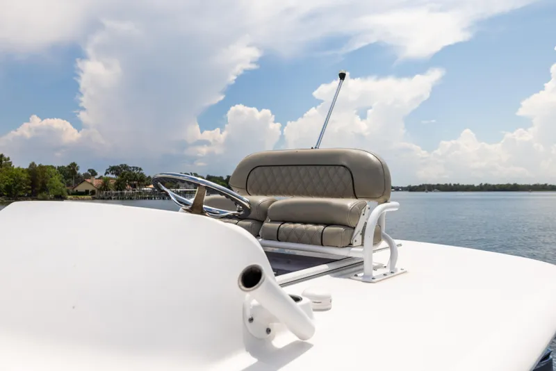 Slide: The Image of 2021 Sportsman Open 302 Center Console boat on a calm lake under a blue sky. - 43