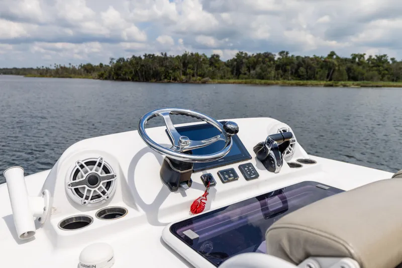 Slide: The Image of 2021 Sportsman Open 302 Center Console boat dashboard on a calm lake. - 45