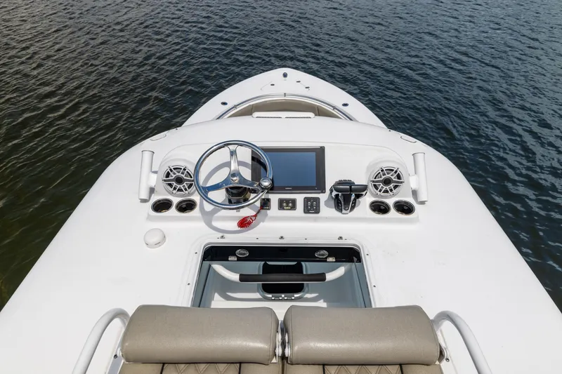 Slide: The Image of 2021 Sportsman Open 302 Center Console boat dashboard on water. - 46