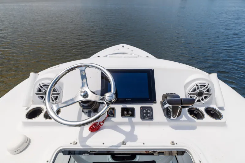 Slide: The Image of 2021 Sportsman Open 302 Center Console helm with steering wheel and electronics. - 47