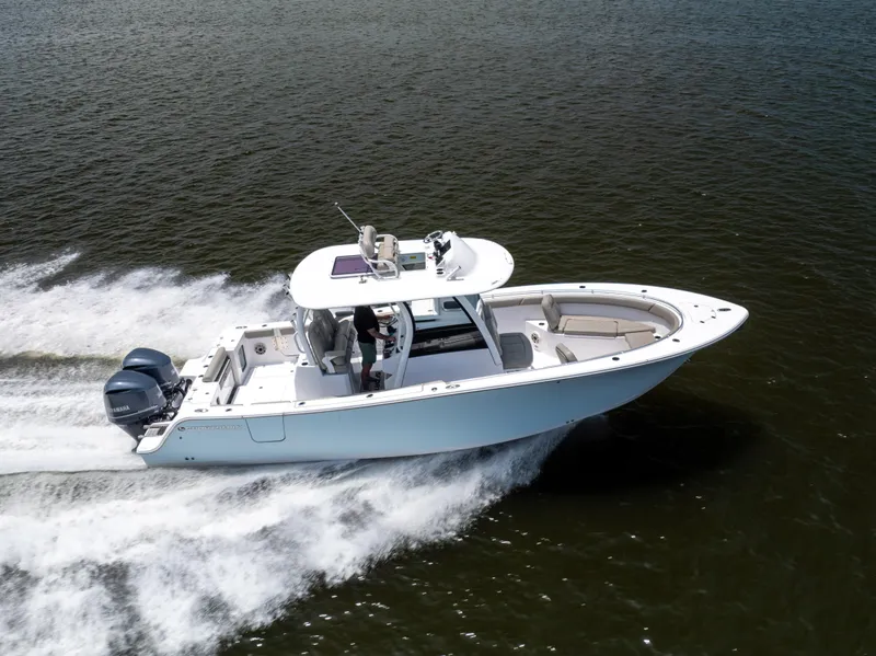 Slide: The Image of 2021 Sportsman Open 302 Center Console boat cruising on water. - 8