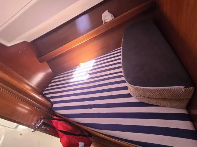 Slide: The Image of Cozy cabin interior of 2003 Beneteau 42CC Oceanis Clipper with striped bedding. - 12