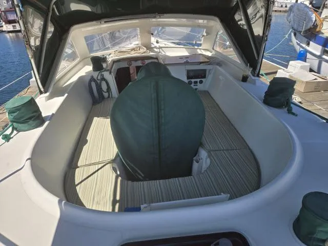 Slide: The Image of 2003 Beneteau 42CC Oceanis Clipper cockpit with green covers and marina view. - 21