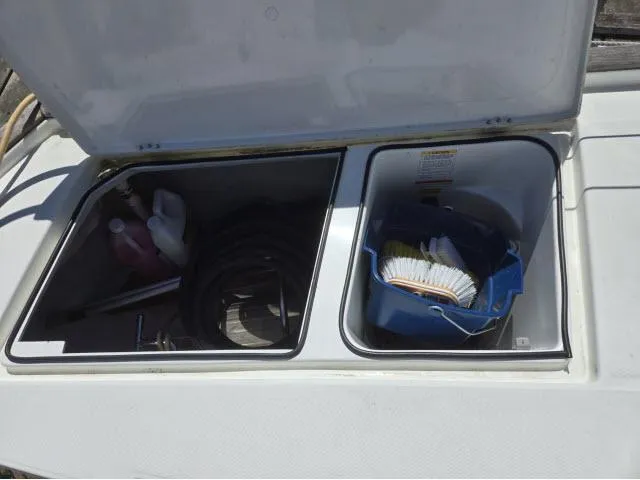 Slide: The Image of Open storage compartments on 2003 Beneteau 42CC Oceanis Clipper with cleaning supplies and equipment. - 26