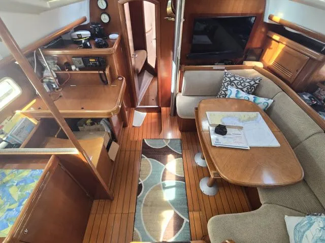 Slide: The Image of Interior of 2003 Beneteau 42CC Oceanis Clipper yacht with cozy seating and navigation area. - 3