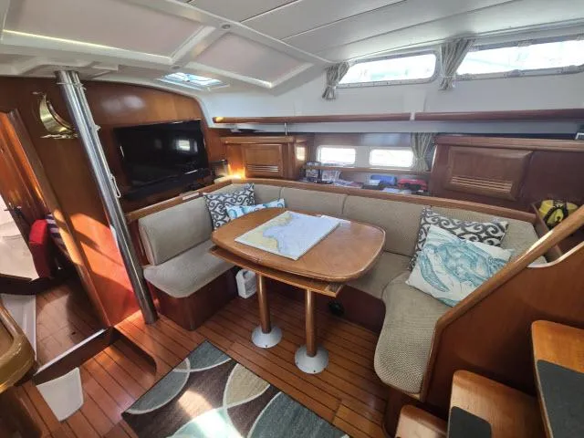 Slide: The Image of Interior of 2003 Beneteau 42CC Oceanis Clipper yacht with cozy seating and wooden finishes. - 4