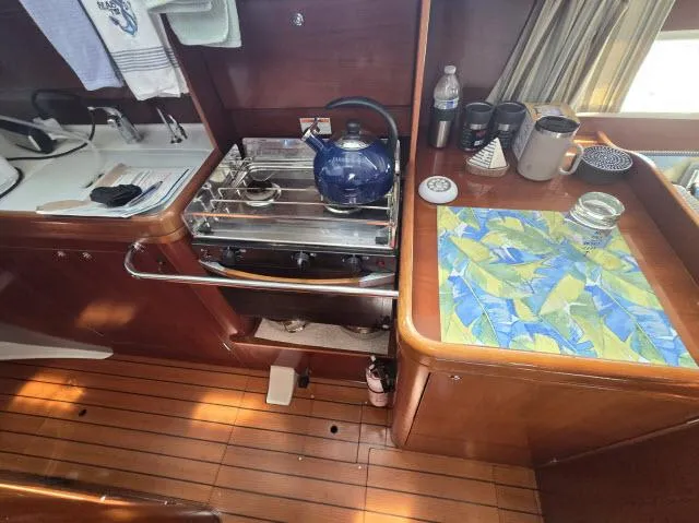 Slide: The Image of Interior of 2003 Beneteau 42CC Oceanis Clipper yacht kitchen with stove and wooden flooring. - 6