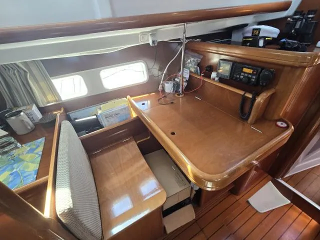 Slide: The Image of Navigation station in 2003 Beneteau 42CC Oceanis Clipper yacht, featuring wood finish and communication equipment. - 8