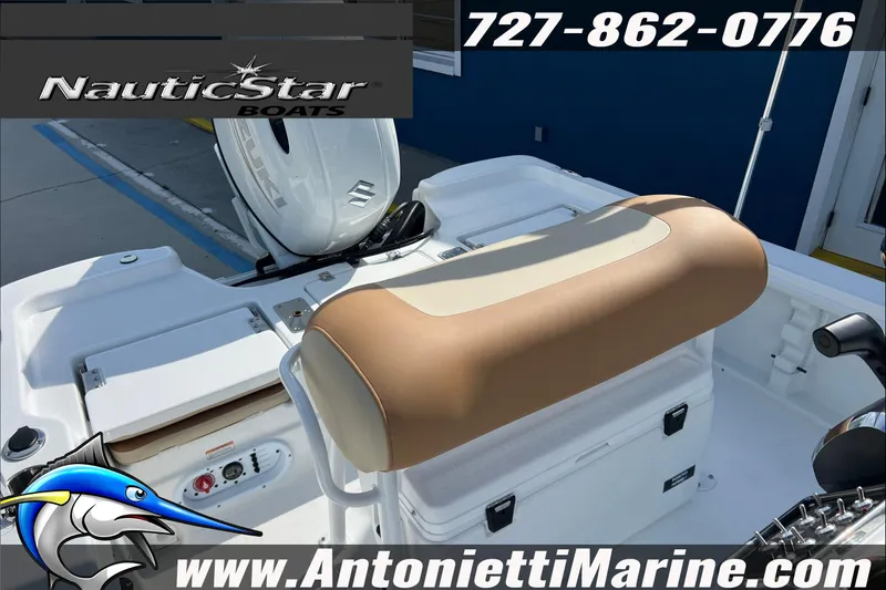 Slide: The Image of 2025 NauticStar 194 Bay boat interior with tan seating and Suzuki engine. - 18