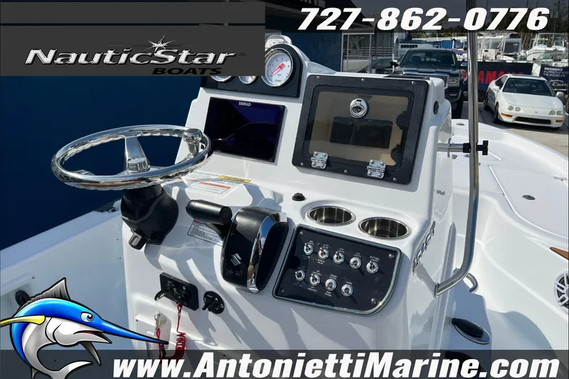 Slide: The Image of 2025 NauticStar 194 Bay boat dashboard with controls and steering wheel at Antonietti Marine. - 19