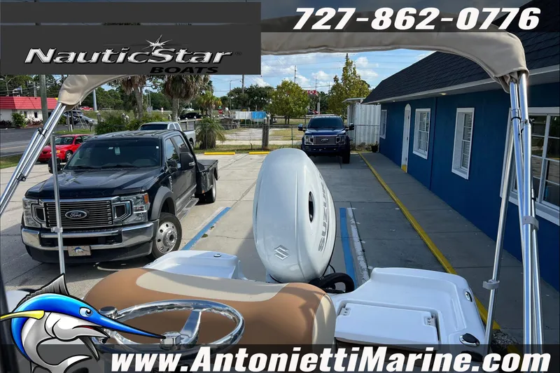 Slide: The Image of 2025 NauticStar 194 Bay boat at Antonietti Marine dealership, featuring Suzuki outboard motor. - 4