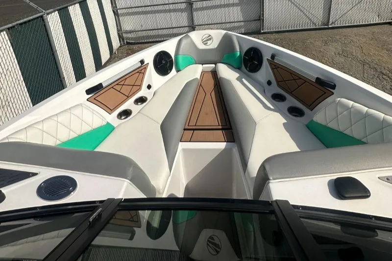 Slide: The Image of 2022 Tigé Z3 boat interior with white and teal seating, wood accents. - 10