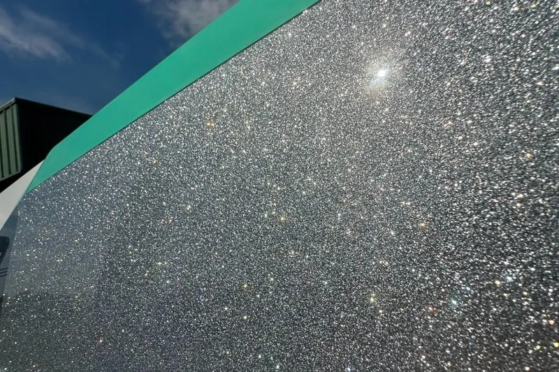 Slide: The Image of 2022 Tigé Z3 boat with sparkling metallic finish under sunlight. - 11