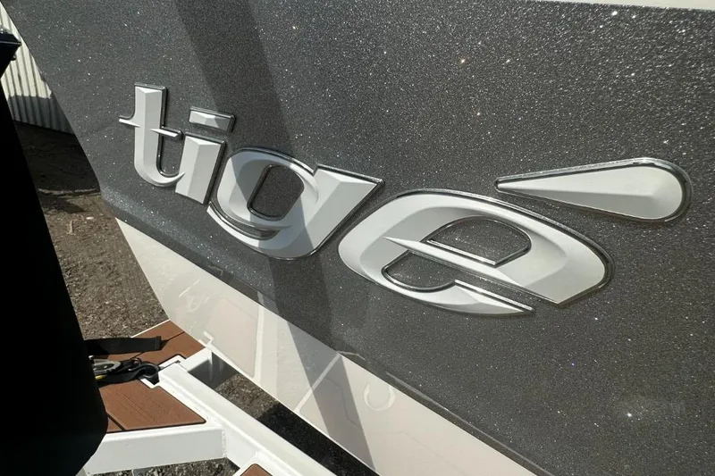 Slide: The Image of 2022 Tigé Z3 boat logo on a sleek, metallic surface. - 13